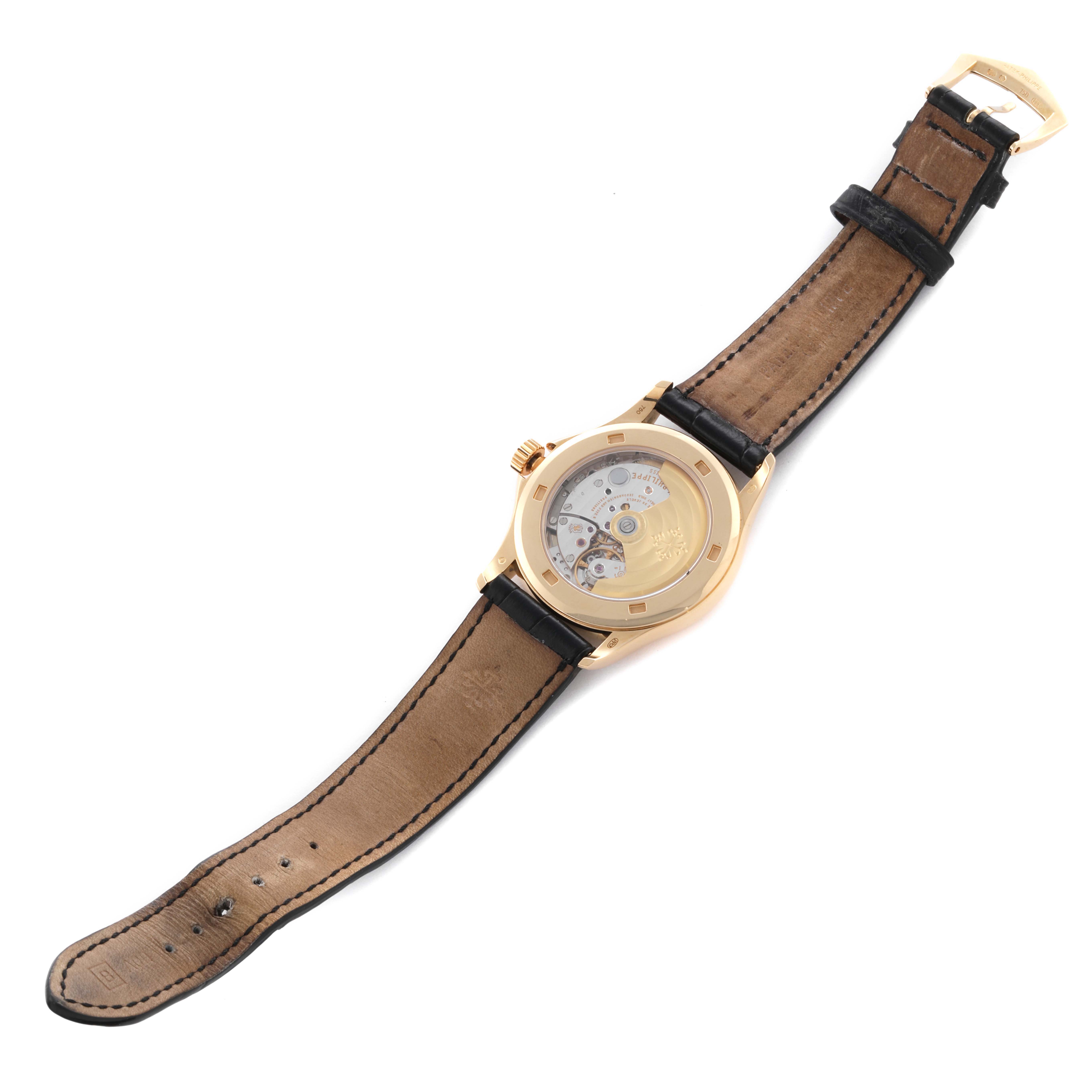 The Patek Philippe Calatrava 5127J-001 Men's Yellow Gold Silver Dial 5127J-001 Men's Yellow Gold Silver Dial watch is shown from the back, highlighting its movement and leather strap.