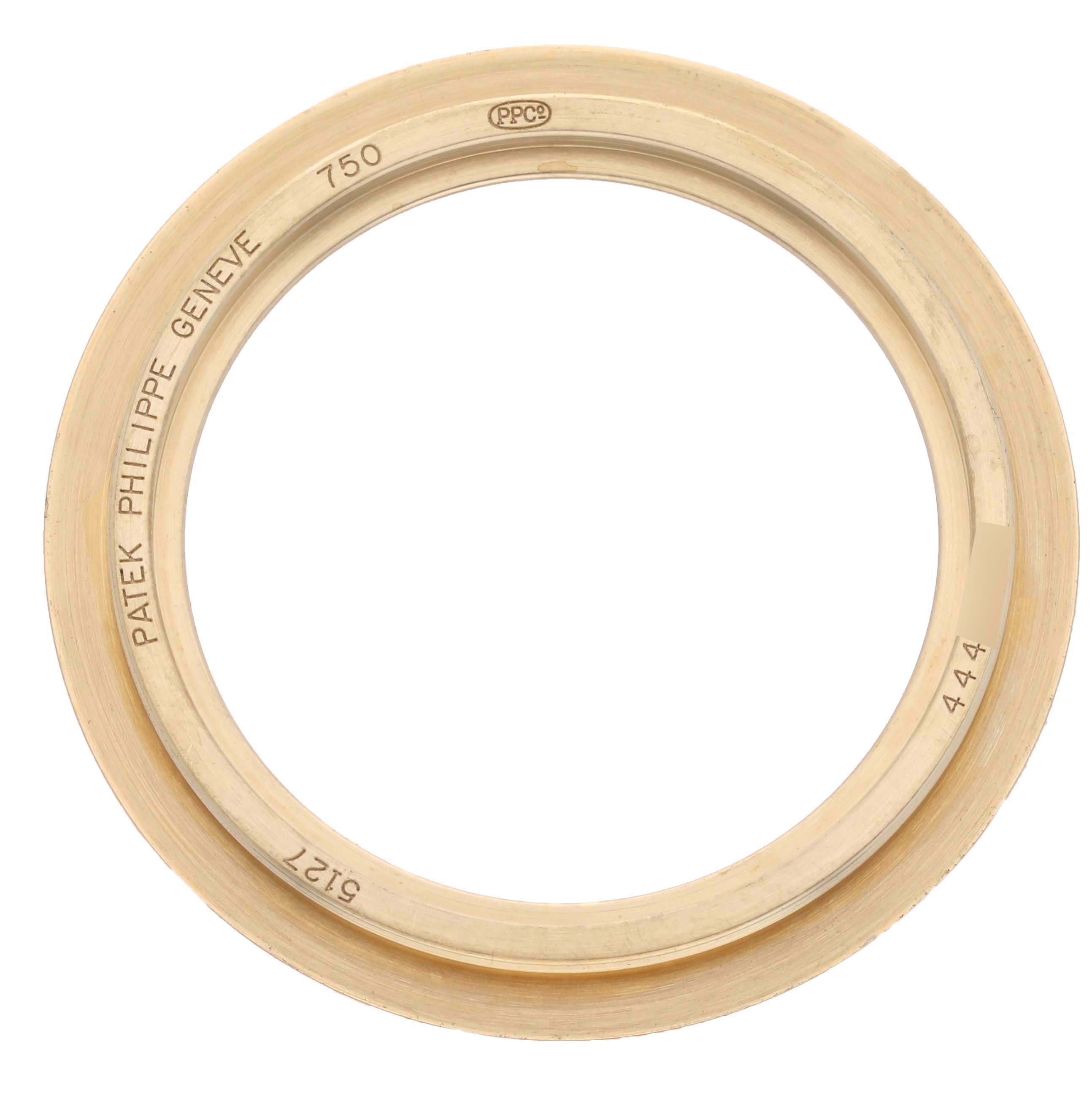 The image shows a bezel from a Patek Philippe Calatrava 5127J-001 Men's Yellow Gold Silver Dial 5127J-001 Men's Yellow Gold Silver Dial watch, viewed from above with engravings visible.