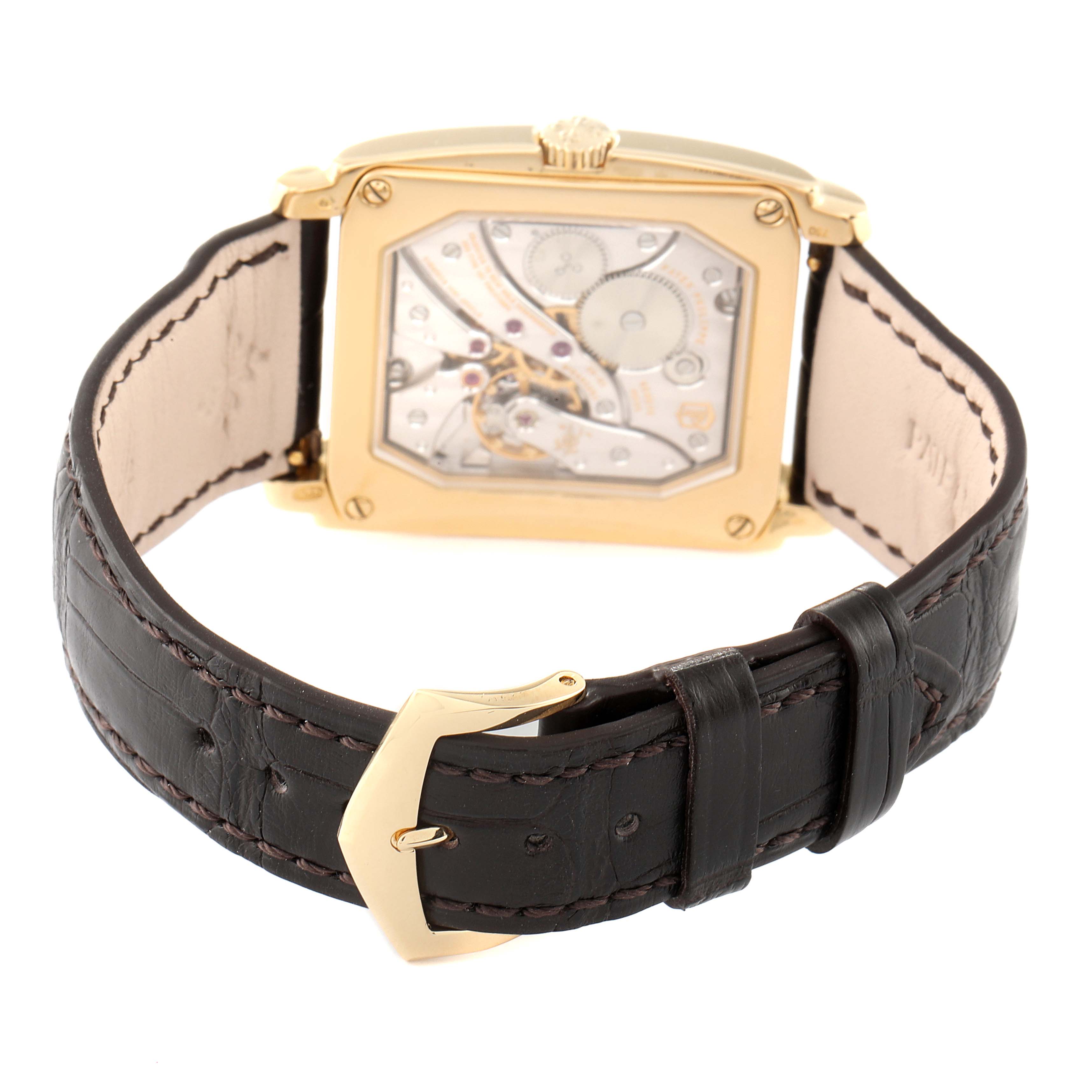 The image shows the back view of the Patek Philippe Gondolo 5124J Men's Yellow Gold Silver Dial 5124J Men's Yellow Gold Silver Dial watch, highlighting its movement and leather strap.