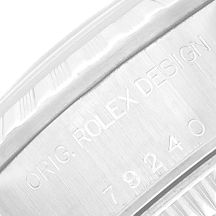 The image shows a close-up of the engraved side detail of the bezel on a Rolex Date 79240 Women's Stainless Steel Pink Dial 79240 Women's Stainless Steel Pink Dial model watch, displaying "ORIG. ROLEX DESIGN 79240."