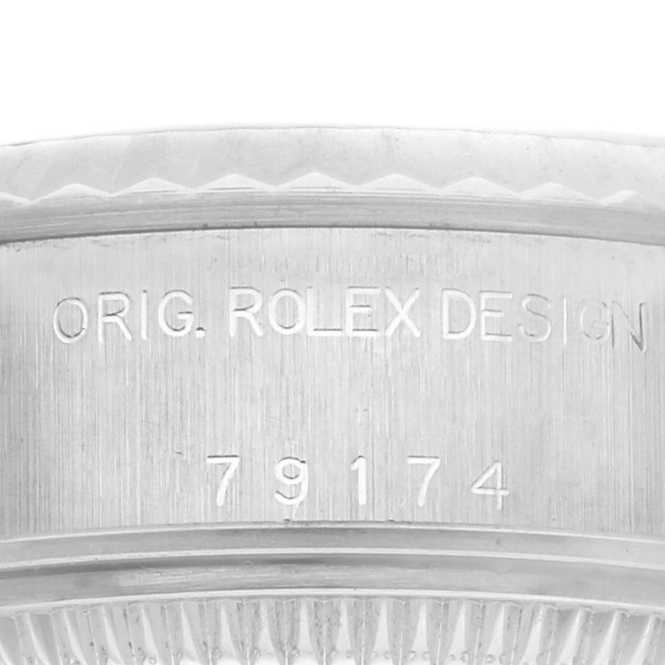 The image shows a close-up of the side of a Rolex Datejust 79174 Women's Stainless Steel Mother of Pearl Dial 79174 Women's Stainless Steel Mother of Pearl Dial watch case, highlighting the engraved "Orig. Rolex Design" and model number.