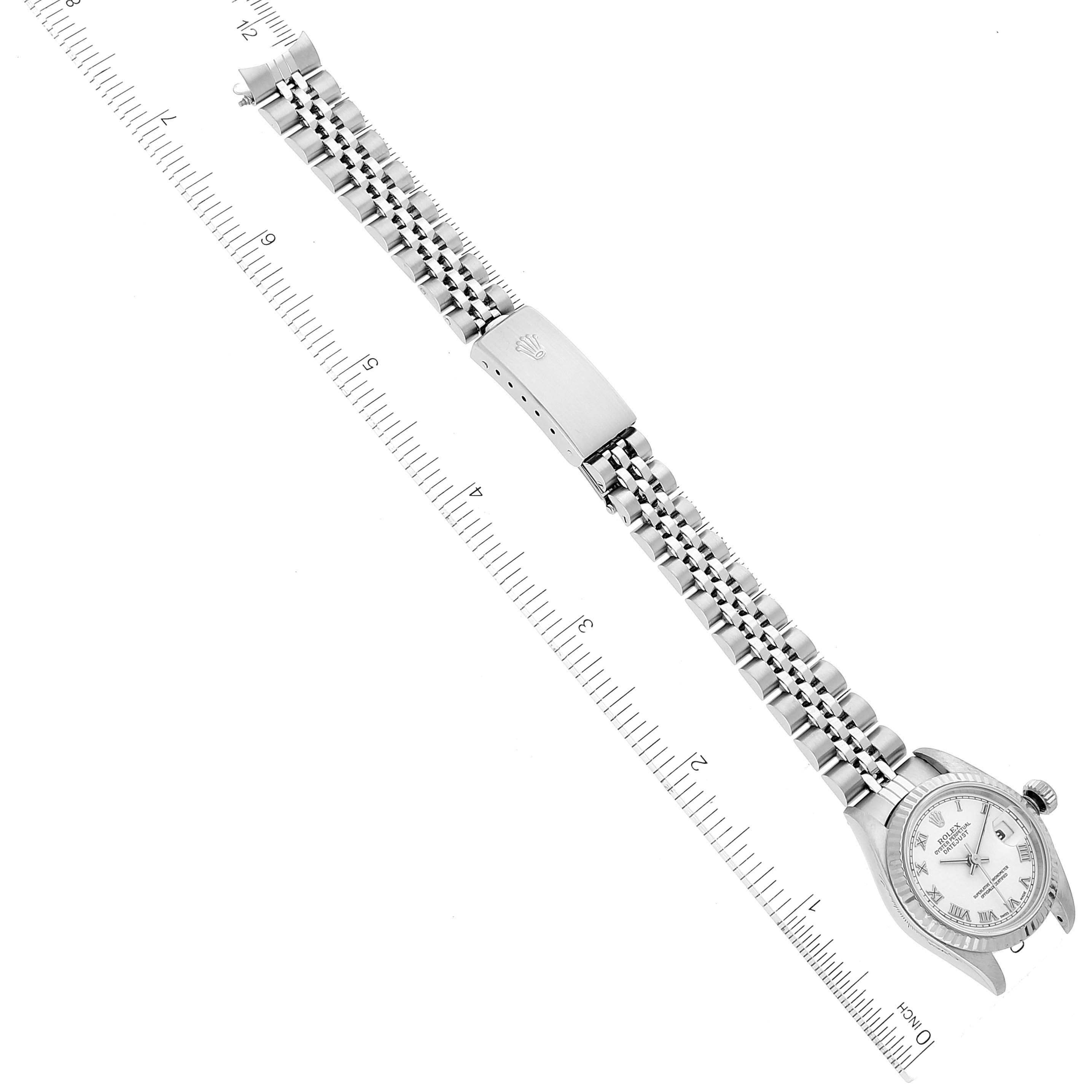This image shows a Datejust Rolex watch laid flat, displaying the face, bracelet, and closed clasp, measured against a ruler.