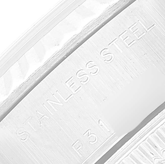 The image shows a close-up of the casing of a Rolex Datejust 79174 Women's Stainless Steel White Dial 79174 Women's Stainless Steel White Dial watch, highlighting the stainless steel part and partial serial number.