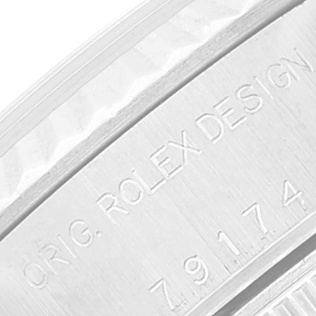 This close-up image shows the engraved text and serial number on the side of a Datejust model by Rolex.
