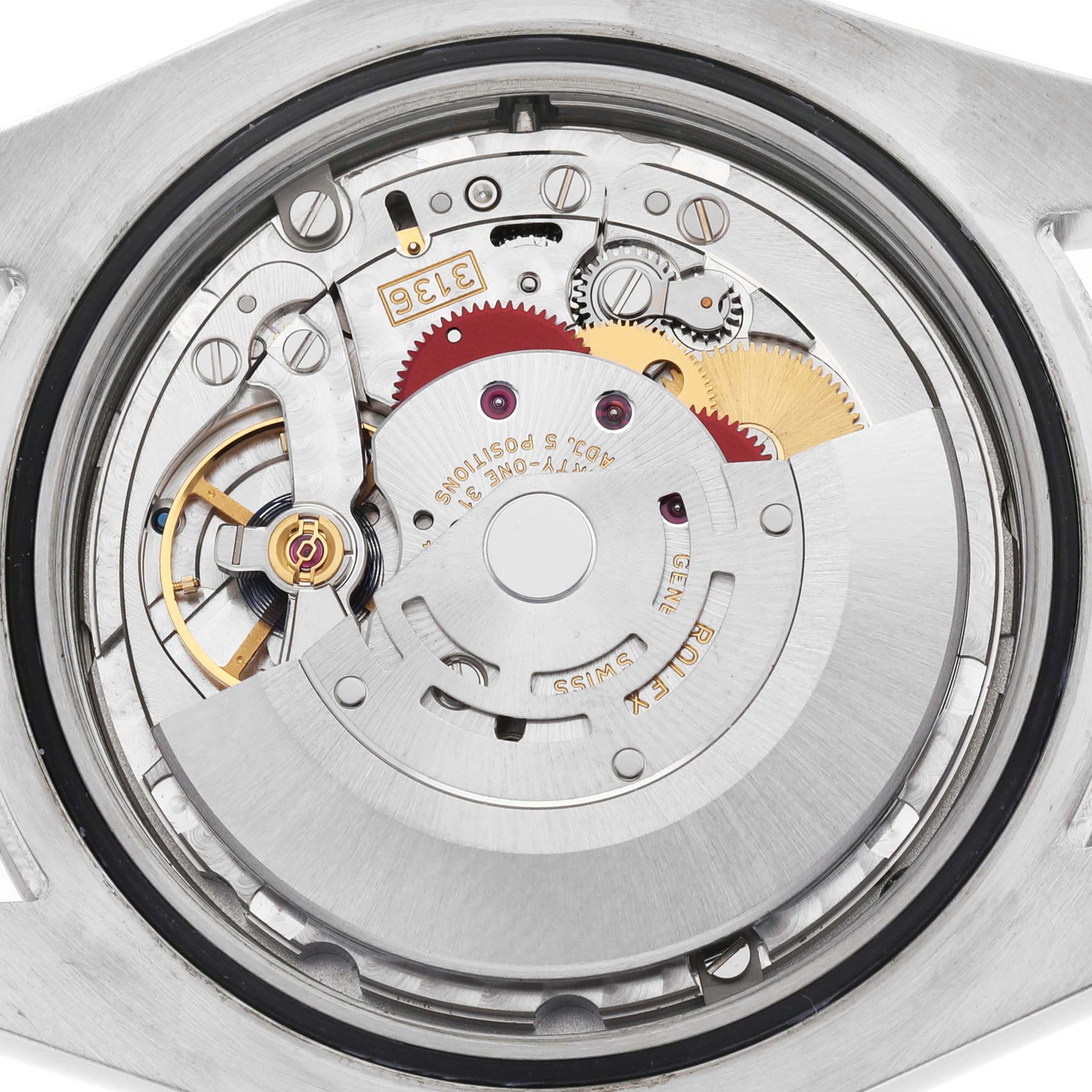 The image shows the movement mechanism of a Rolex Datejust 41 116334 Men's Stainless Steel Silver Dial, viewed from the back, highlighting gears and components.
