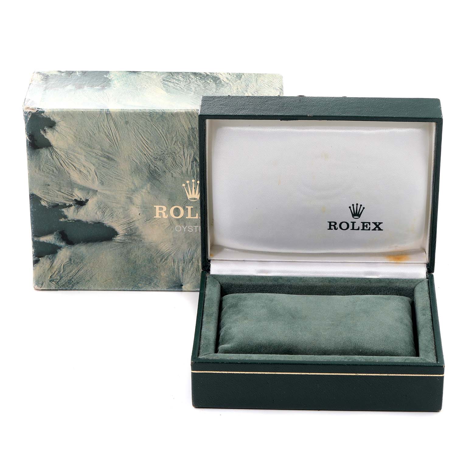 The image shows an open Rolex watch box with a cushion, displaying the Rolex logo, and its outer packaging, angled from the front.