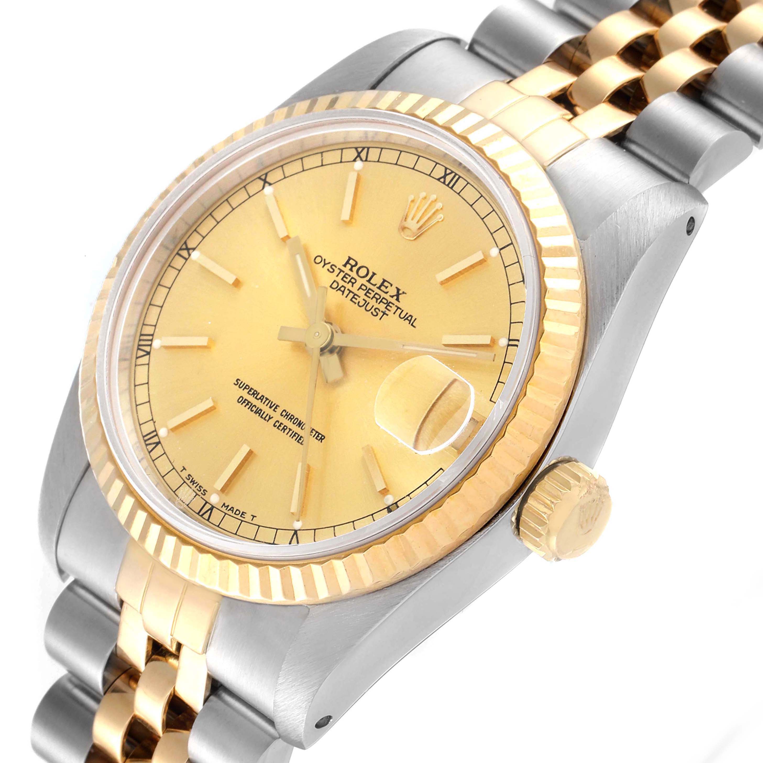 The image shows a Mid-Size Rolex Oyster Perpetual Datejust watch at an angled view, highlighting its gold dial and two-tone bracelet.