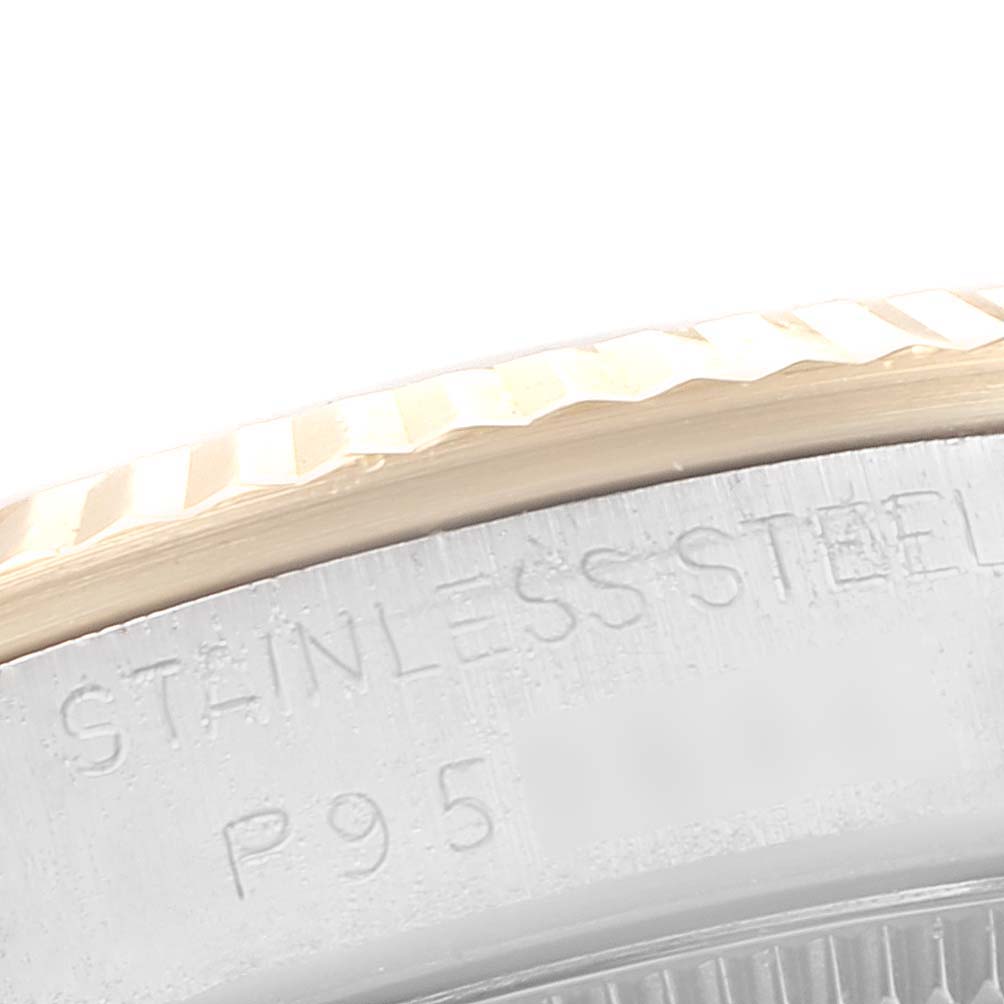 This image shows a close-up of the fluted bezel and stainless steel engraving on the side of a Rolex Mid-Size 68273 Women's Stainless Steel Champagne Dial 68273 Women's Stainless Steel Champagne Dial watch.