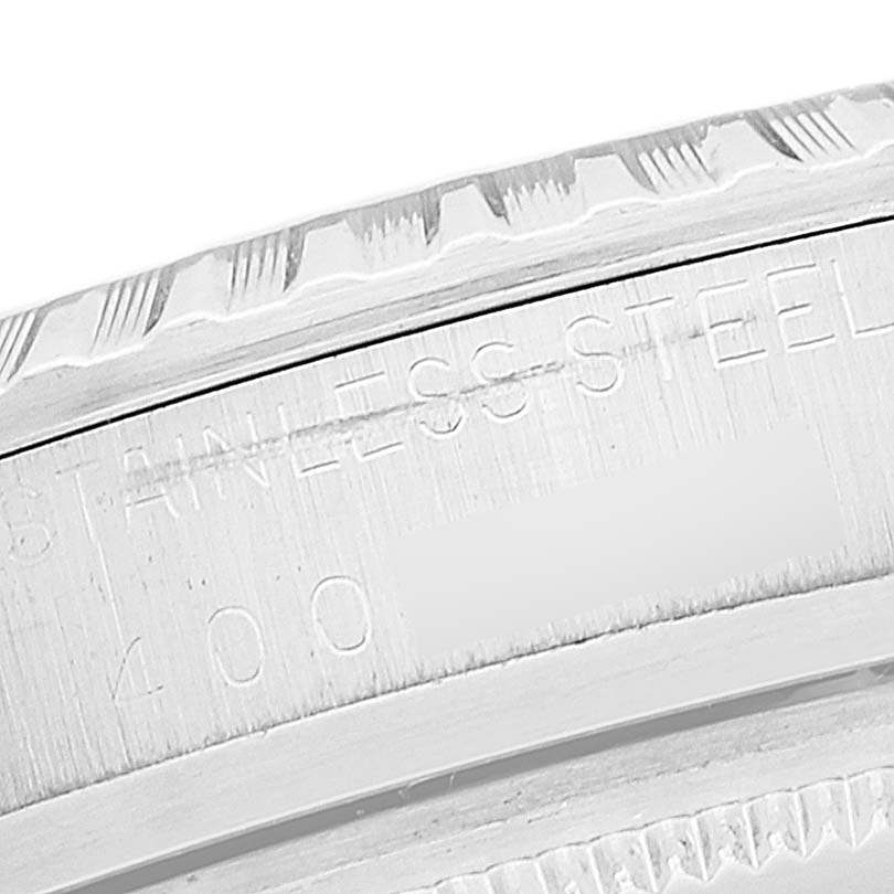 The close-up image shows the stainless steel engraved bezel with notches and serial number of a Rolex Vintage Collection 1603 Men's Stainless Steel Silver Dial 1603 Men's Stainless Steel Silver Dial model watch.