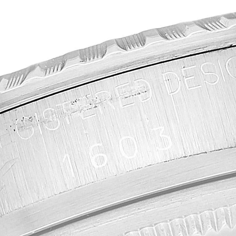 The image shows a close-up of the engraved bezel and case side of a Rolex Vintage Collection 1603 Men's Stainless Steel Silver Dial 1603 Men's Stainless Steel Silver Dial model watch.