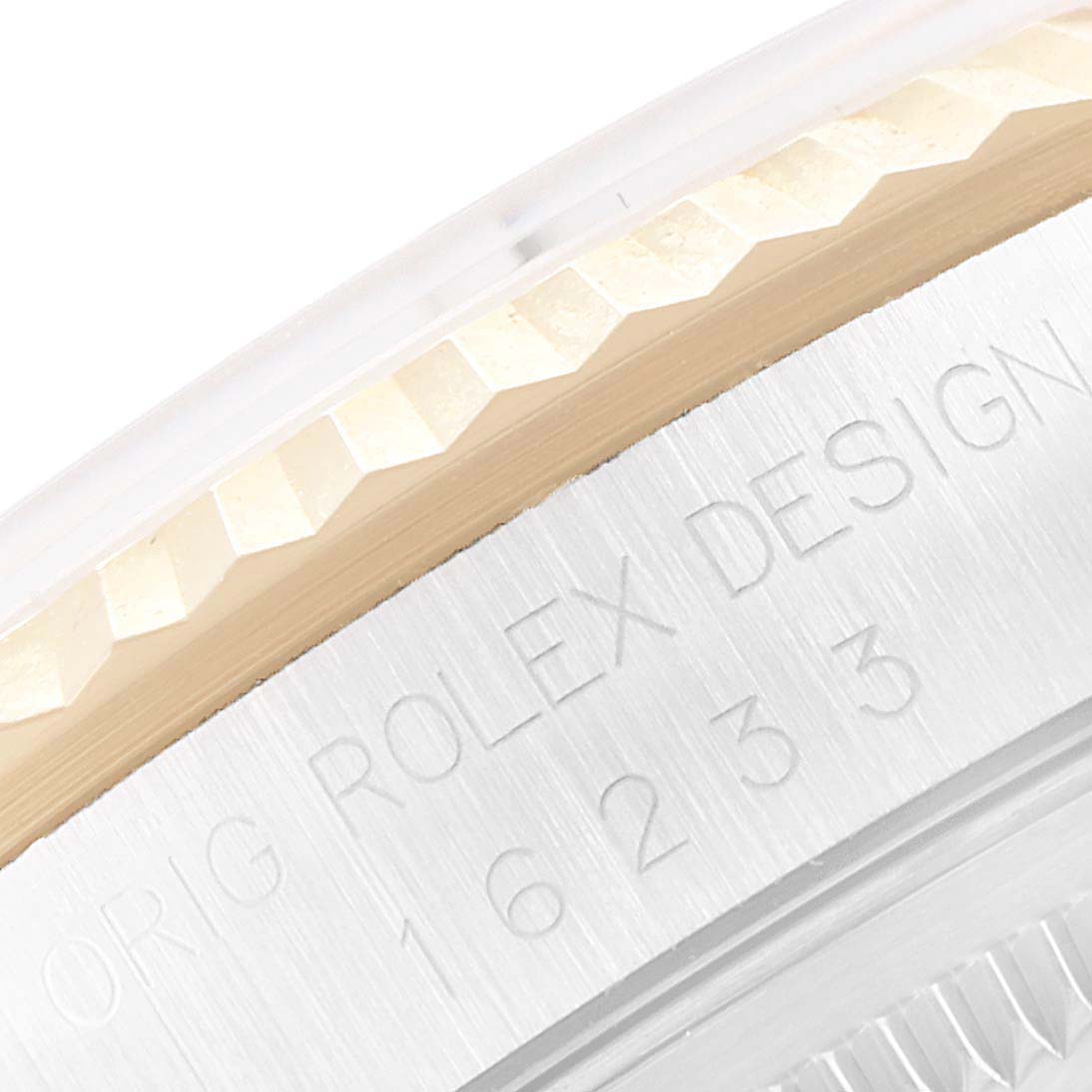 This image shows a close-up of the engraved bezel and case edge of a Rolex Datejust 16233 Men's Steel and Gold (two tone) White Dial 16233 Men's Steel and Gold (two tone) White Dial watch.