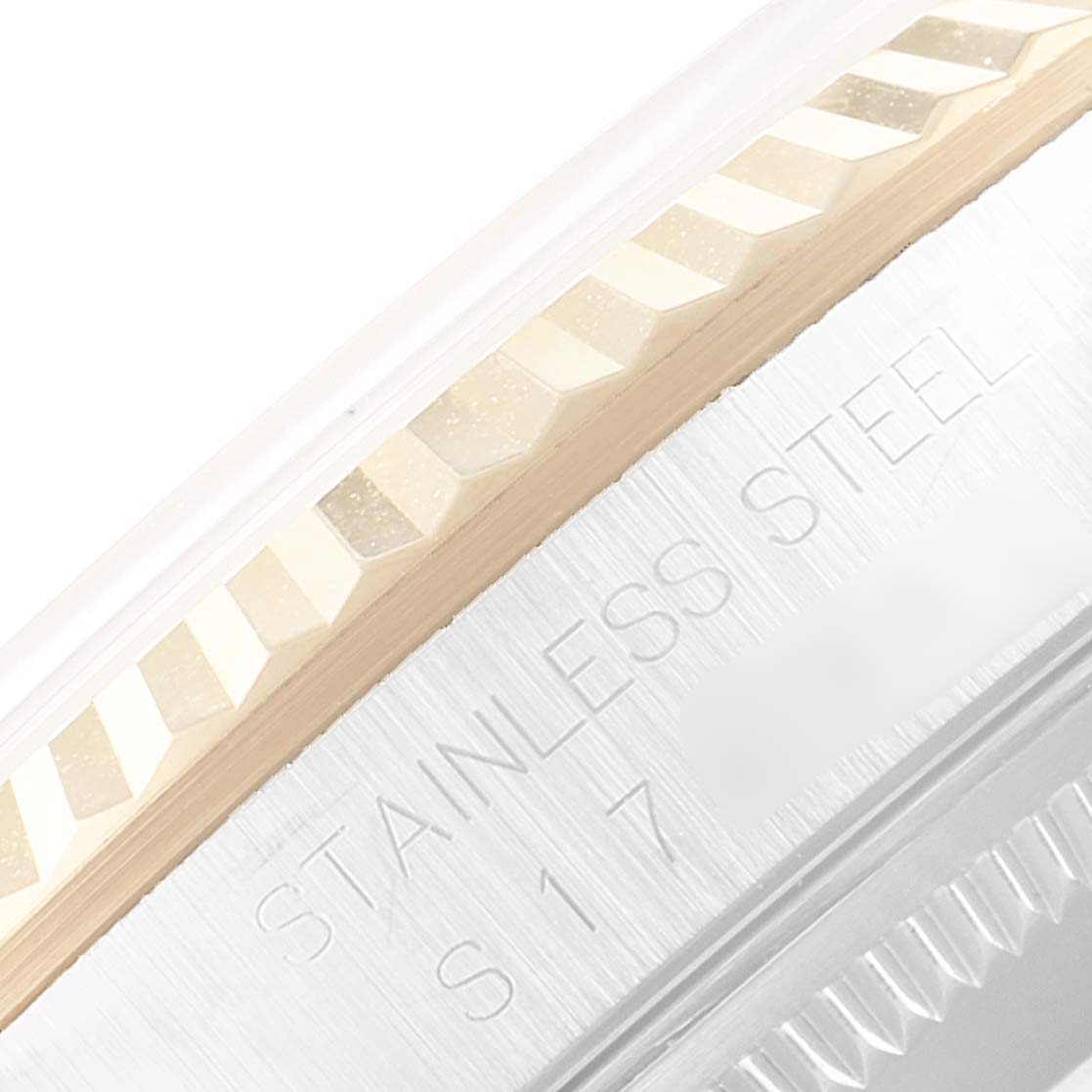 The image shows a close-up of the fluted bezel and part of the stainless steel casing of a Rolex Datejust 16233 Men's Steel and Gold (two tone) White Dial 16233 Men's Steel and Gold (two tone) White Dial watch.