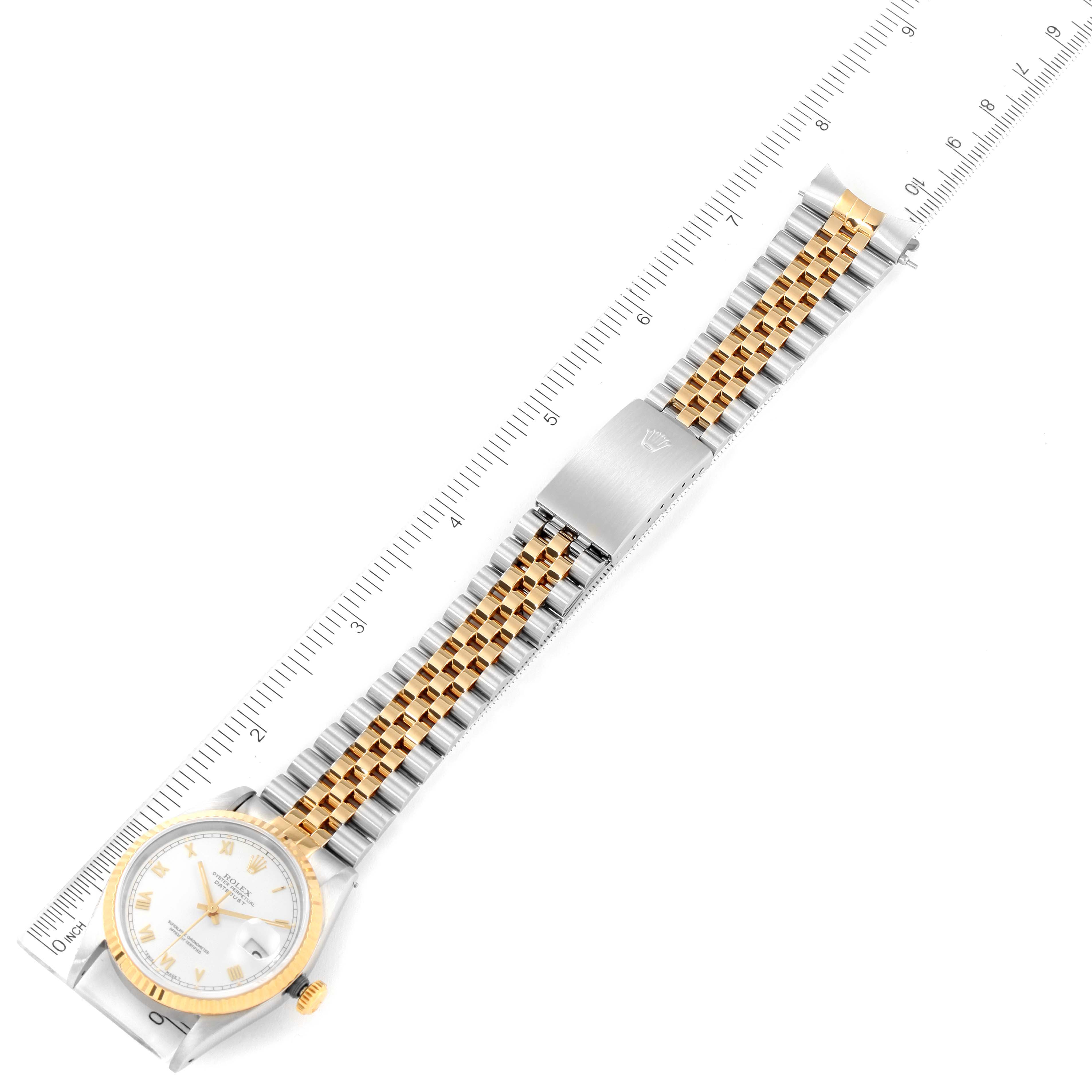 The image shows a Rolex Datejust 16233 Men's Steel and Gold (two tone) White Dial 16233 Men's Steel and Gold (two tone) White Dial watch, featuring a silver and gold Jubilee bracelet, along with a ruler for measurement.