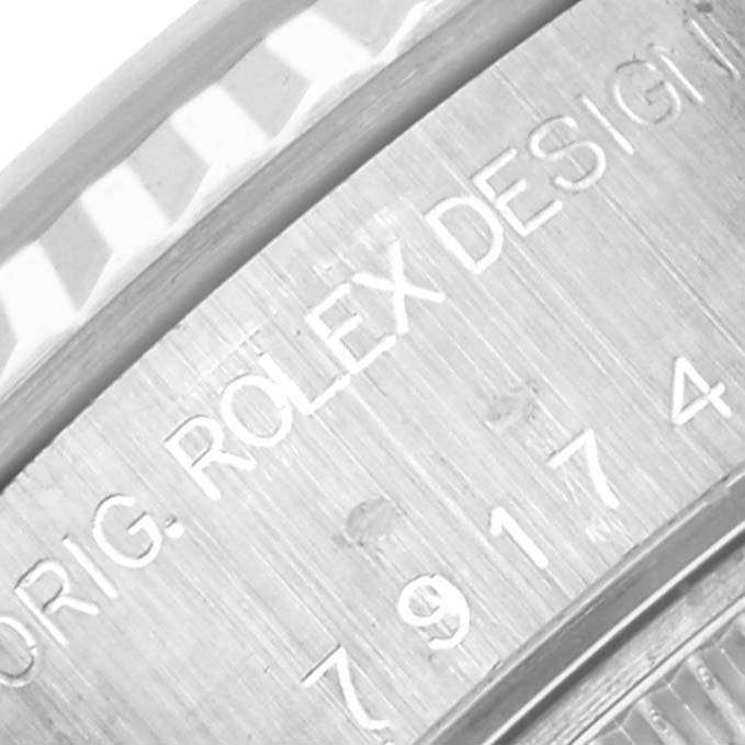 The image shows a close-up of the case engraving on a Rolex Datejust 79174 Women's Stainless Steel Silver Dial 79174 Women's Stainless Steel Silver Dial watch, highlighting branding details.