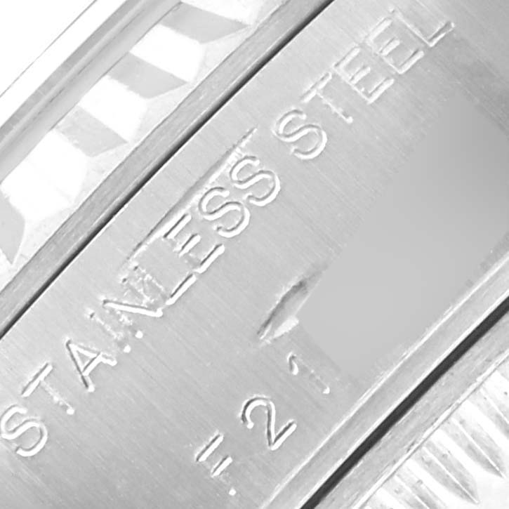 The image shows a close-up of the engraved text on a stainless steel part of a Rolex Datejust 79174 Women's Stainless Steel Silver Dial 79174 Women's Stainless Steel Silver Dial watch.