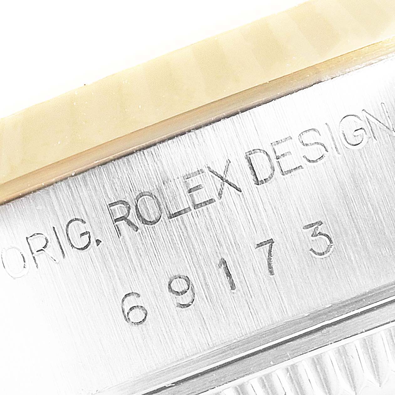 This image shows a close-up of the case side and bezel of a Rolex Datejust 69173 Women
s Stainless Steel Silver Dial 69173 Women
s Stainless Steel Silver Dial, featuring engravings.