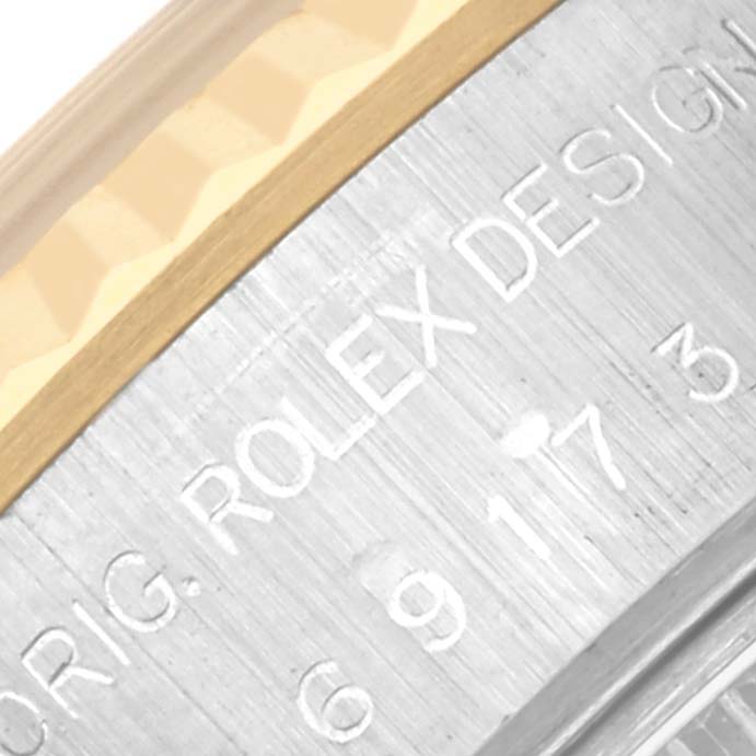 The image shows a close-up of the Rolex Datejust 69173 Women's Steel and Gold (two tone) Champagne Dial 69173 Women's Steel and Gold (two tone) Champagne Dial's bezel and engraved design text.