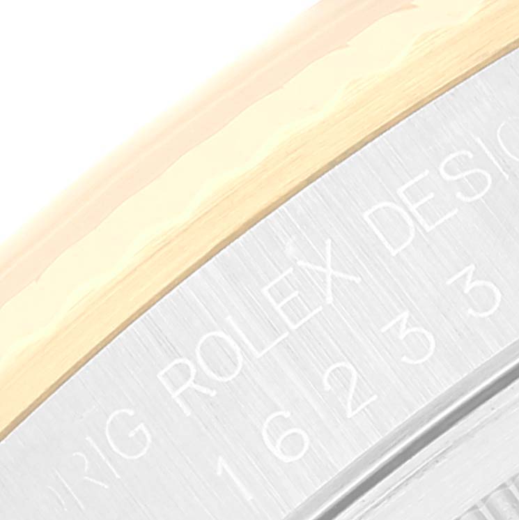 This is a close-up of the case side, featuring the "ORIG ROLEX DESIGN" engraving on a Rolex Datejust 16233 Men's Steel and Gold (two tone) Champagne Dial 16233 Men's Steel and Gold (two tone) Champagne Dial model.