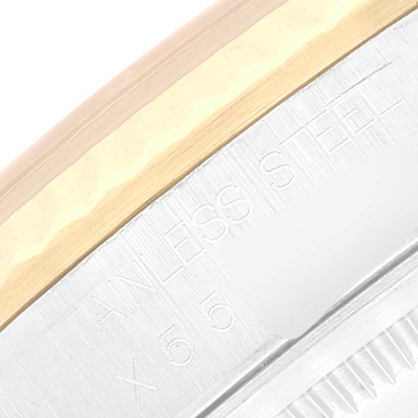 This close-up image shows the side view of a Rolex Datejust 16233 Men's Steel and Gold (two tone) Champagne Dial 16233 Men's Steel and Gold (two tone) Champagne Dial watch, highlighting the stainless steel and gold bezel.