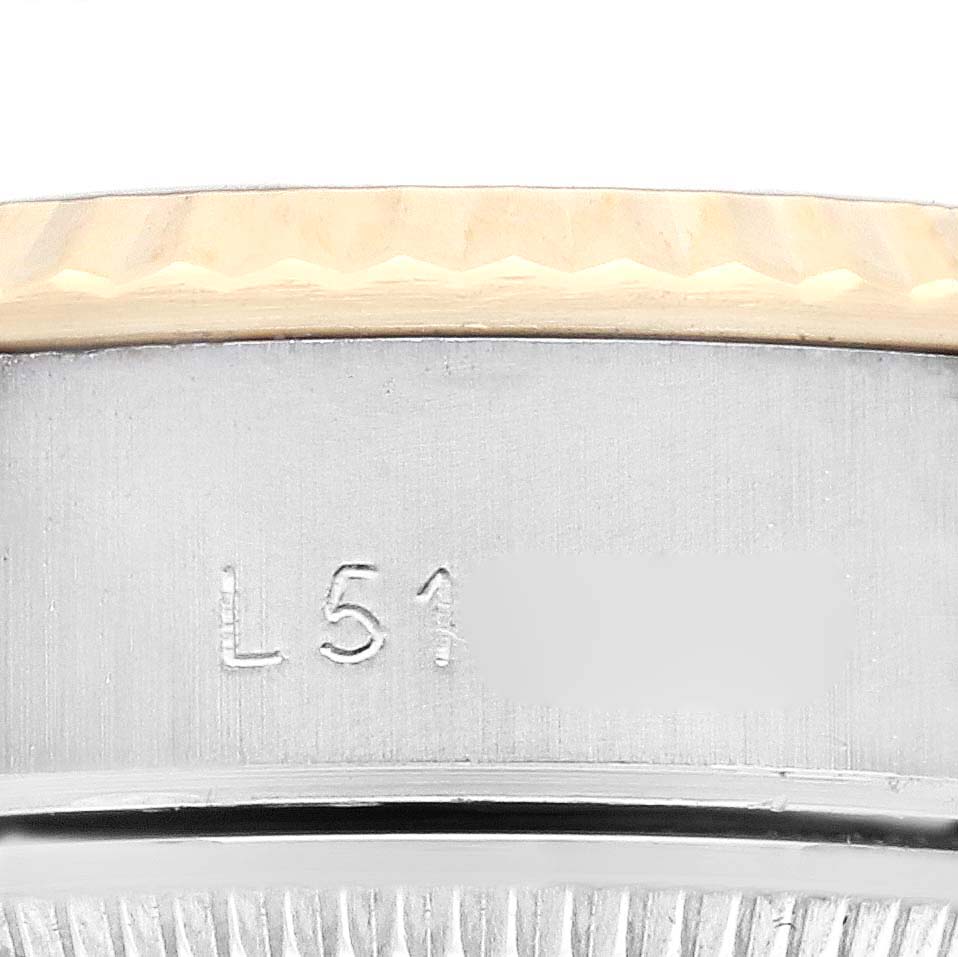 The image shows the side engraving under the bezel of a Rolex Datejust 69173 Women's Steel and Gold (two tone) Champagne Dial 69173 Women's Steel and Gold (two tone) Champagne Dial watch.