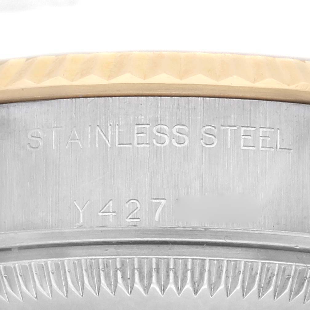 The image shows the Rolex Datejust 79173 Women's Steel and Gold (two tone) Champagne Dial 79173 Women's Steel and Gold (two tone) Champagne Dial's edge, featuring the stainless steel case and fluted bezel engravings.