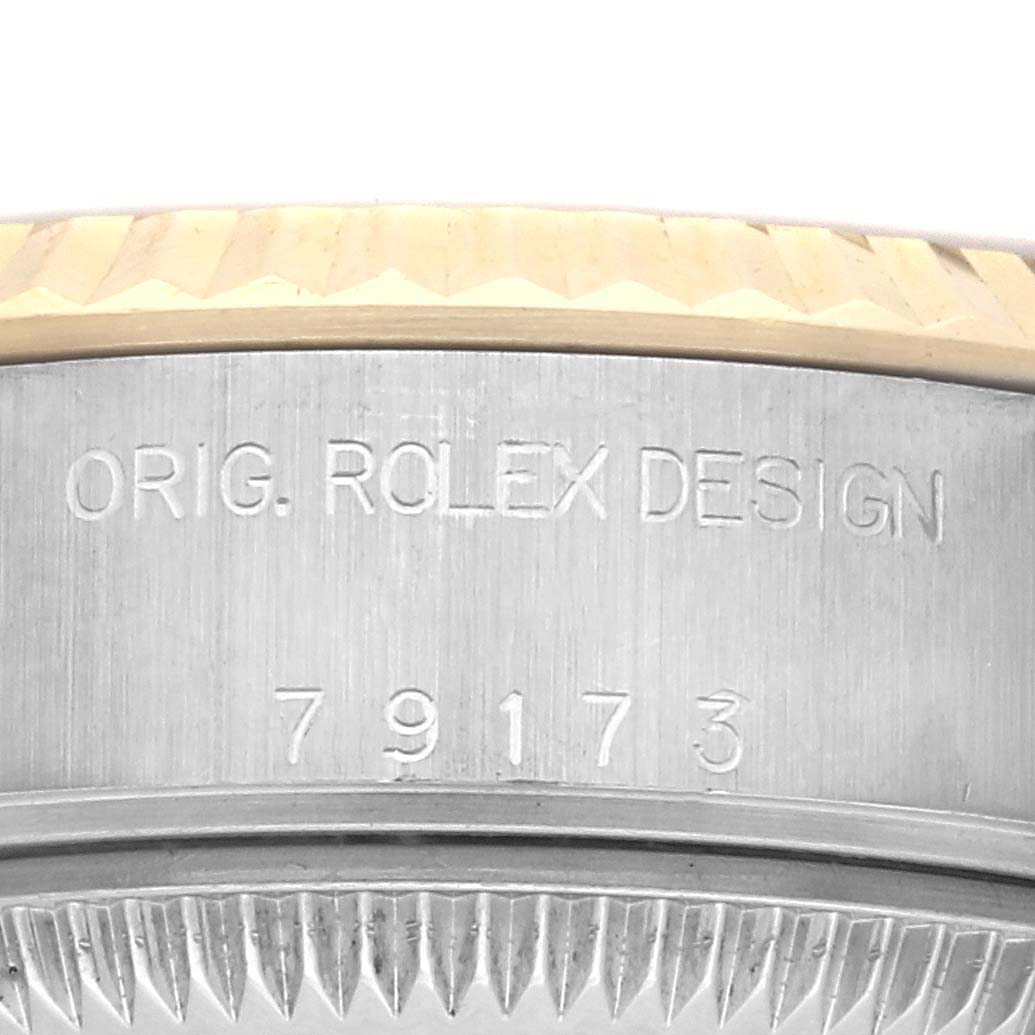 The image shows a close-up of the Rolex Datejust 79173 Women's Steel and Gold (two tone) Champagne Dial 79173 Women's Steel and Gold (two tone) Champagne Dial case side, featuring model engraving.