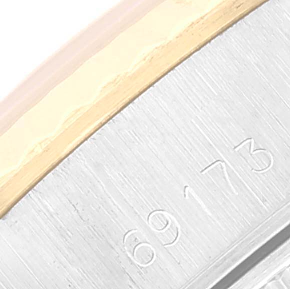 This is a close-up of the side of a Rolex Datejust 69173 Women's Steel and Gold (two tone) Silver Dial 69173 Women's Steel and Gold (two tone) Silver Dial watch, showcasing the engraved serial number.