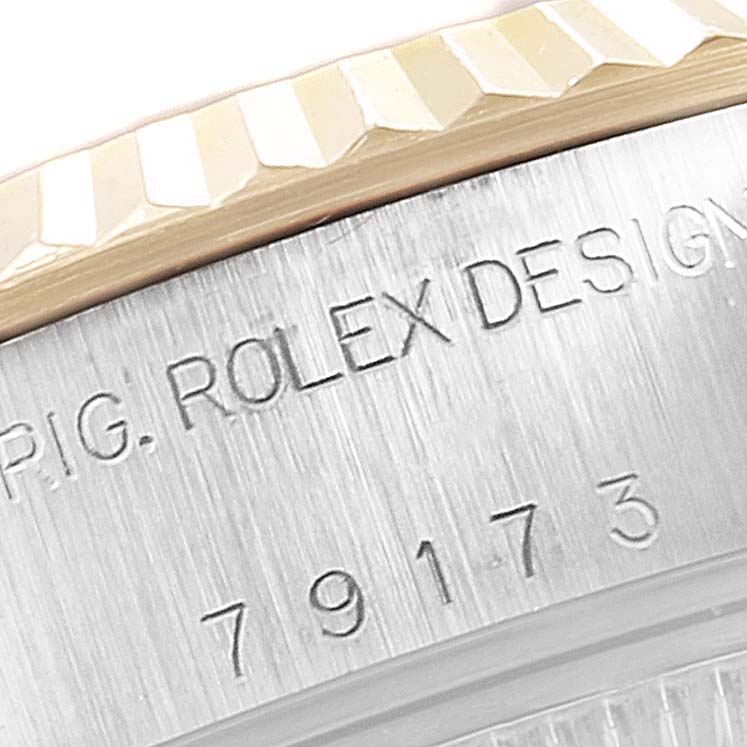 This close-up image shows the bezel and part of the casing with inscriptions of a Rolex Datejust 79173 Women's Steel and Gold (two tone) Pink Dial 79173 Women's Steel and Gold (two tone) Pink Dial watch.