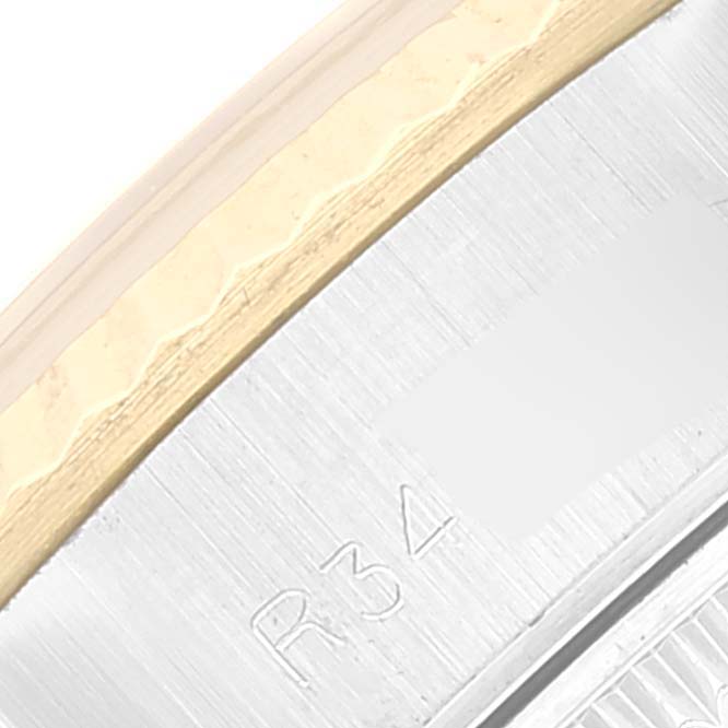 This image shows a close-up of the bezel and the edge of the case back of a Rolex Datejust 69173 Women's Steel and Gold (two tone) Champagne Dial 69173 Women's Steel and Gold (two tone) Champagne Dial watch.