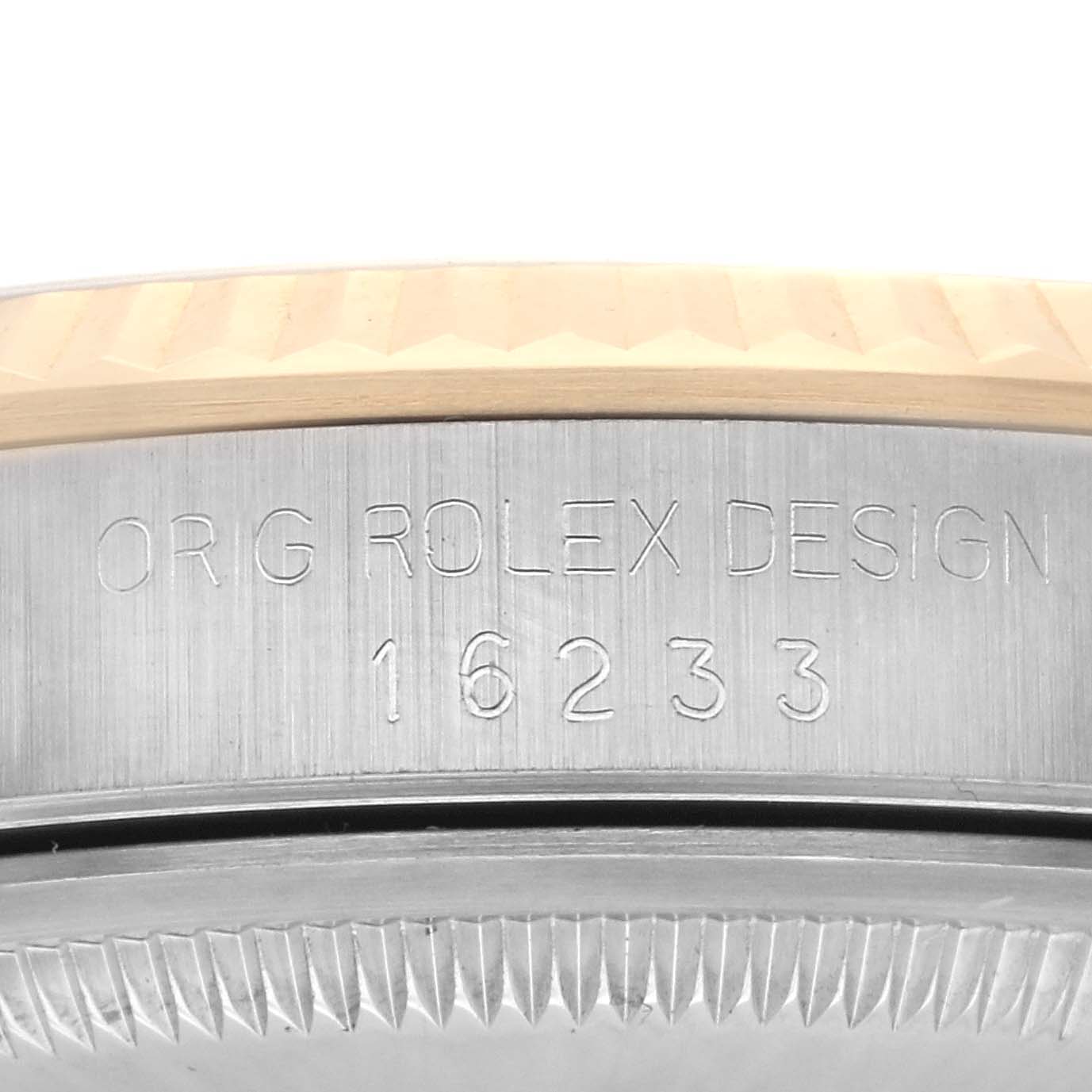 The image shows a close-up of the engraved bezel and case side with model number 16233 of the Rolex Datejust 16233 Men's Steel and Gold (two tone) White Dial 16233 Men's Steel and Gold (two tone) White Dial.