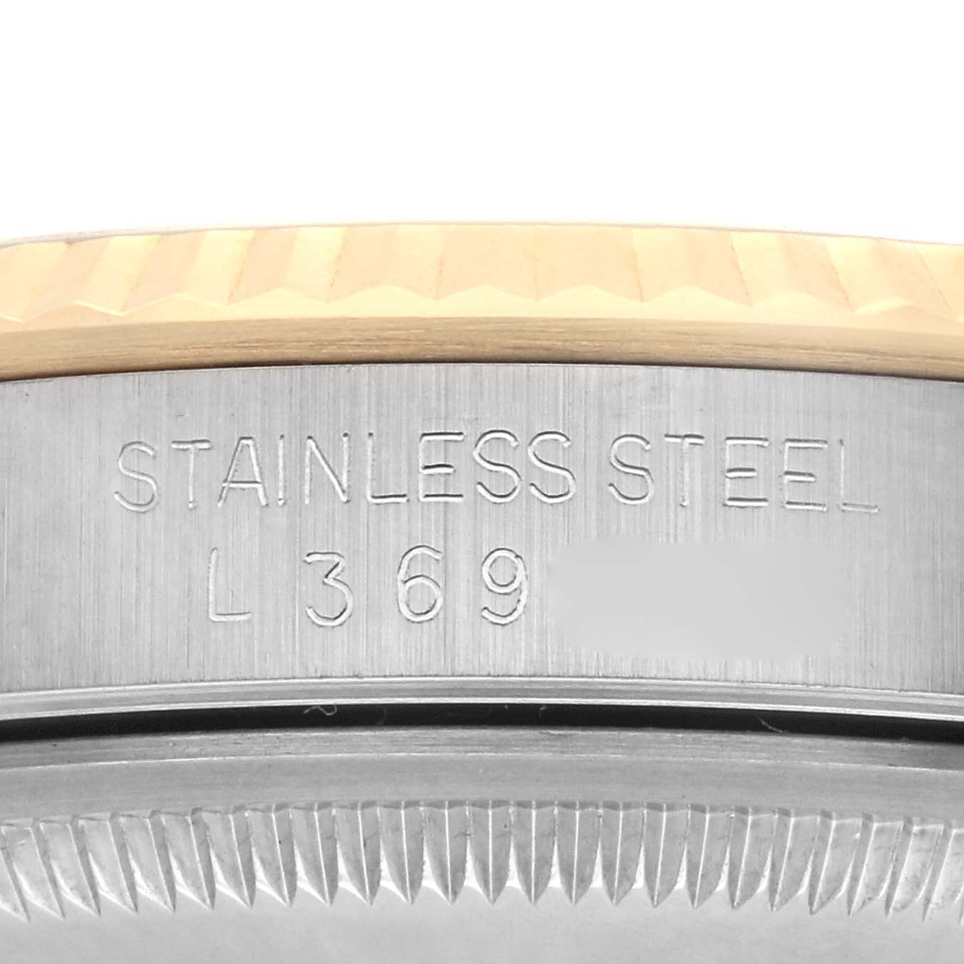 The image shows a close-up of the side of the Rolex Datejust 16233 Men's Steel and Gold (two tone) White Dial 16233 Men's Steel and Gold (two tone) White Dial, focusing on the engraved stainless steel case details.
