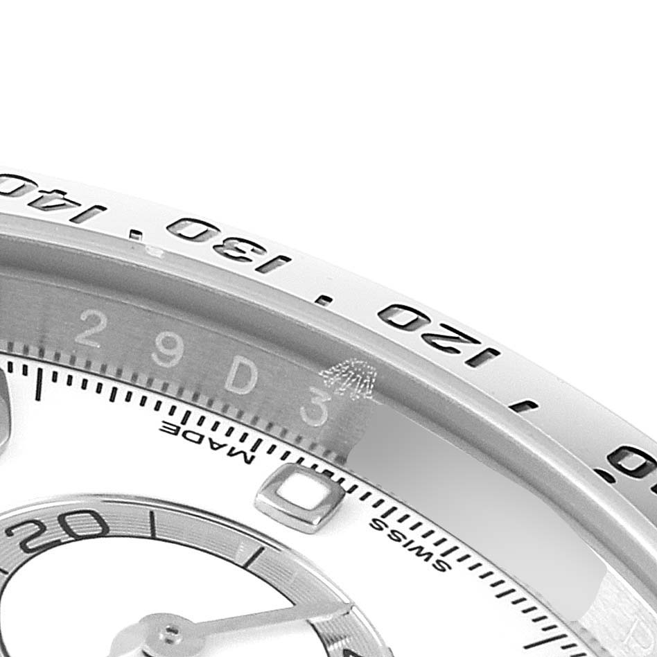 This image shows a close-up of the bezel and part of the dial of a Rolex Daytona 116520 Men's Stainless Steel White Dial 116520 Men's Stainless Steel White Dial watch.