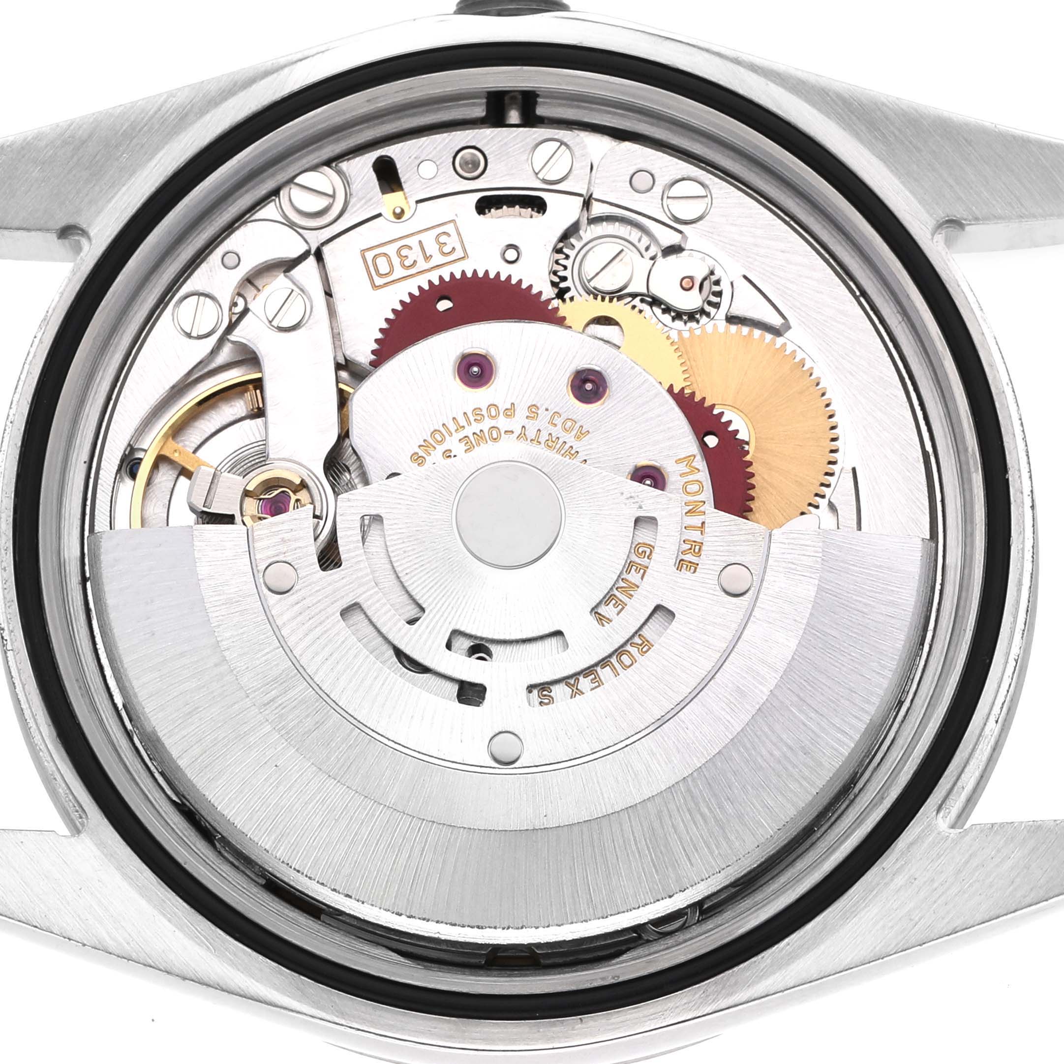 The image shows the movement of the Rolex Explorer 114270 Men's Stainless Steel Black Dial watch from a top-down angle, highlighting gears and intricate internal components.