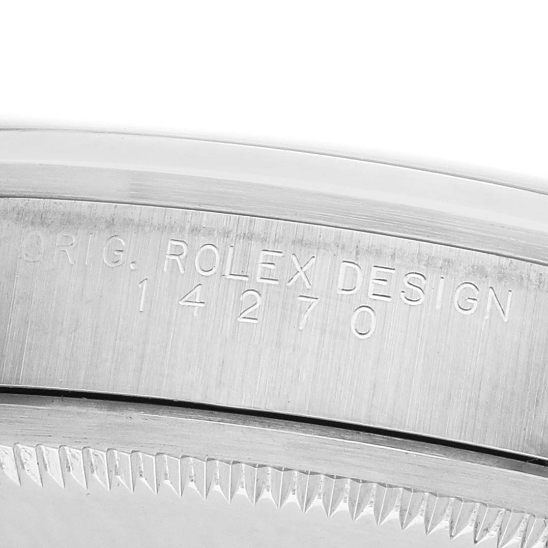 The image shows a close-up of the engraved side of a Rolex Explorer 14270 Men's Stainless Steel Black Dial model, featuring the model number and part of the bezel.