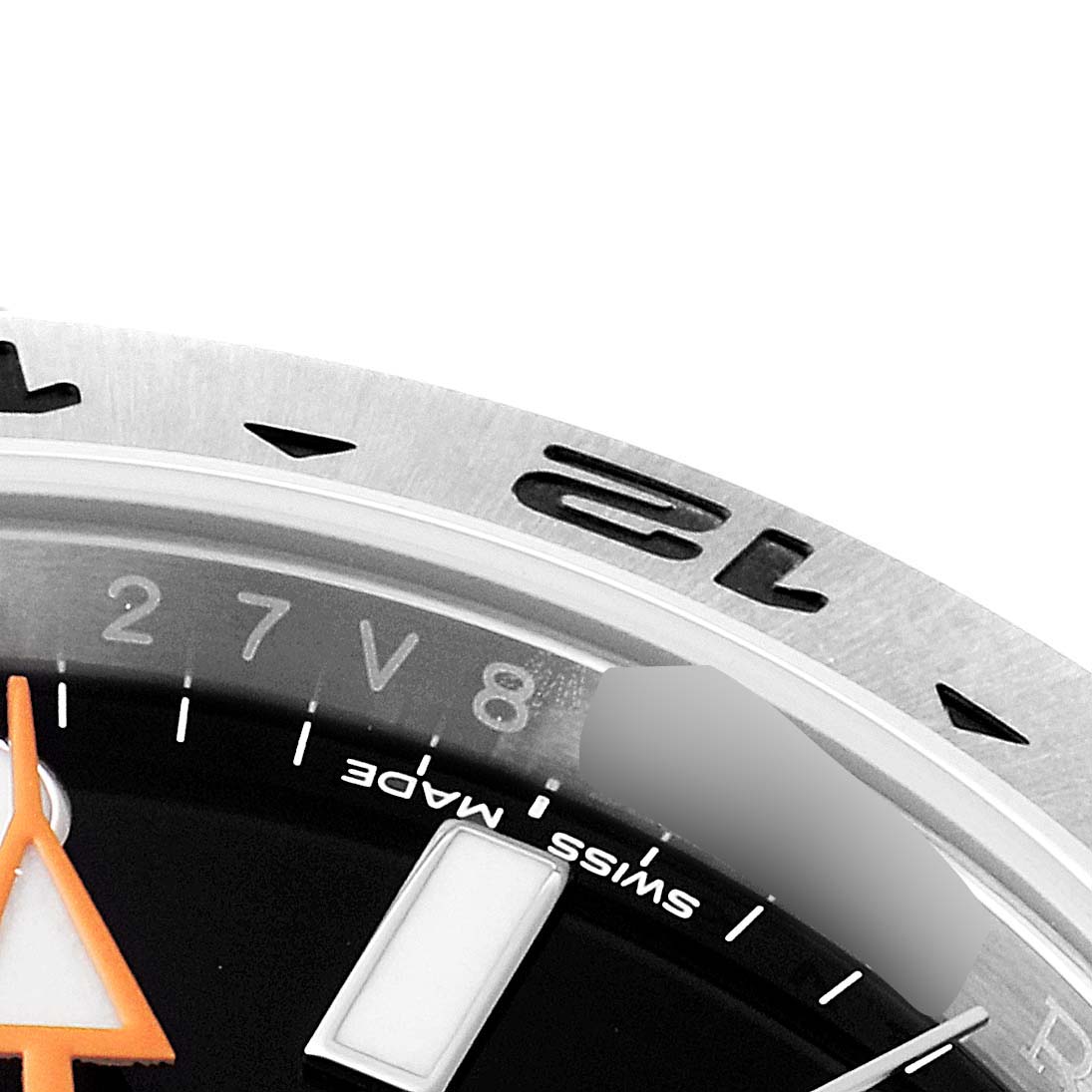 This image shows a close-up of the Rolex Explorer 216570 Men
s Stainless Steel Black Dial 216570 Men
s Stainless Steel Black Dial watch bezel, dial, indices, and part of the orange hand.