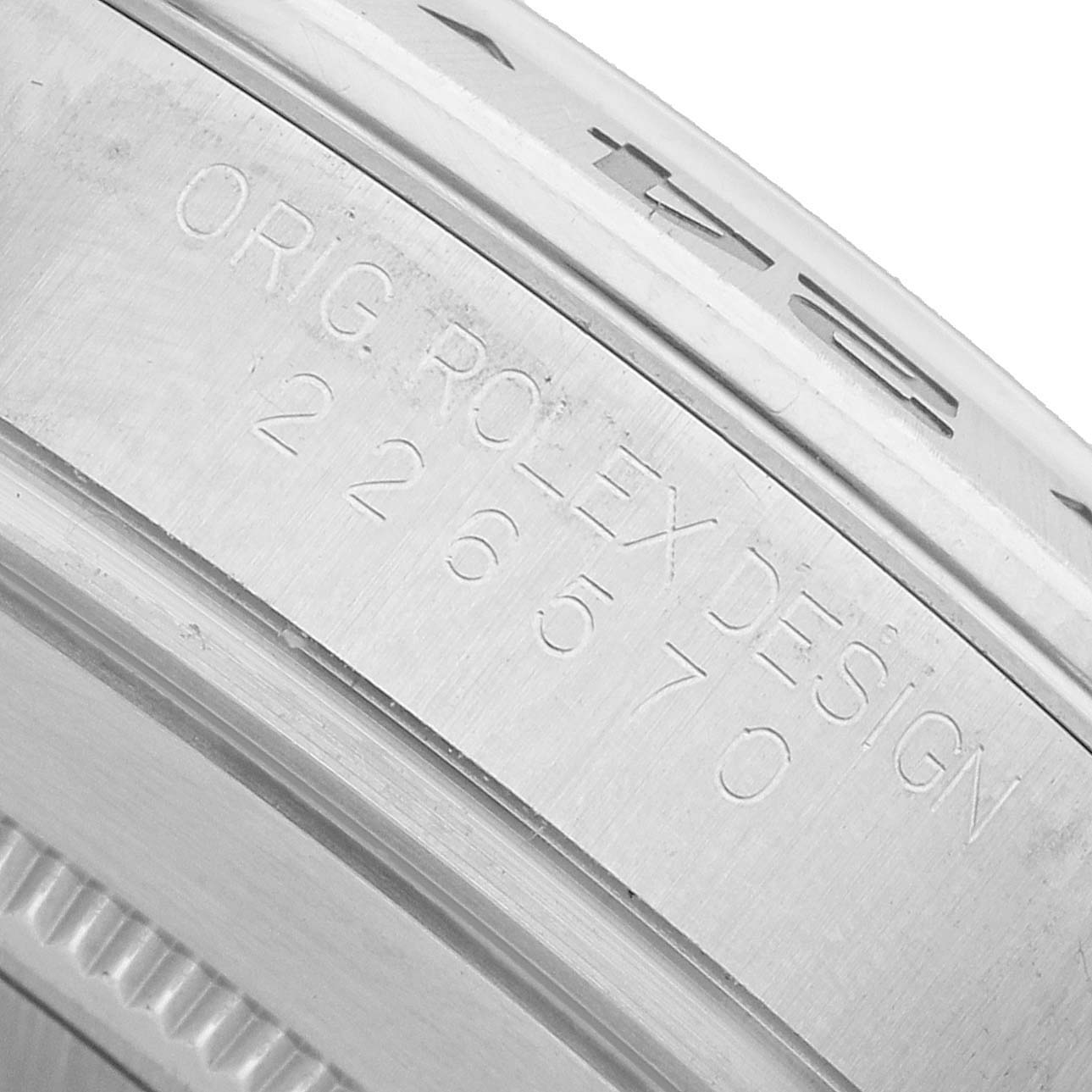 The image shows a close-up of the engraved edge on a Rolex Explorer 226570 Men's Stainless Steel Black Dial watch.