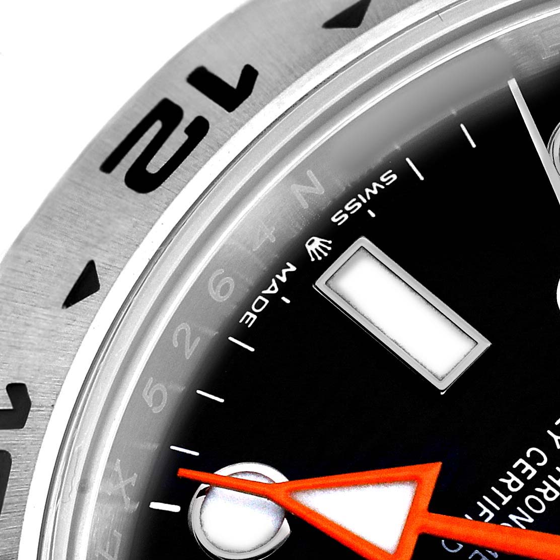 The image shows a close-up of the Rolex Explorer 226570 Men's Stainless Steel Black Dial's bezel, dial, and hands at an angled view, highlighting its markings and details.