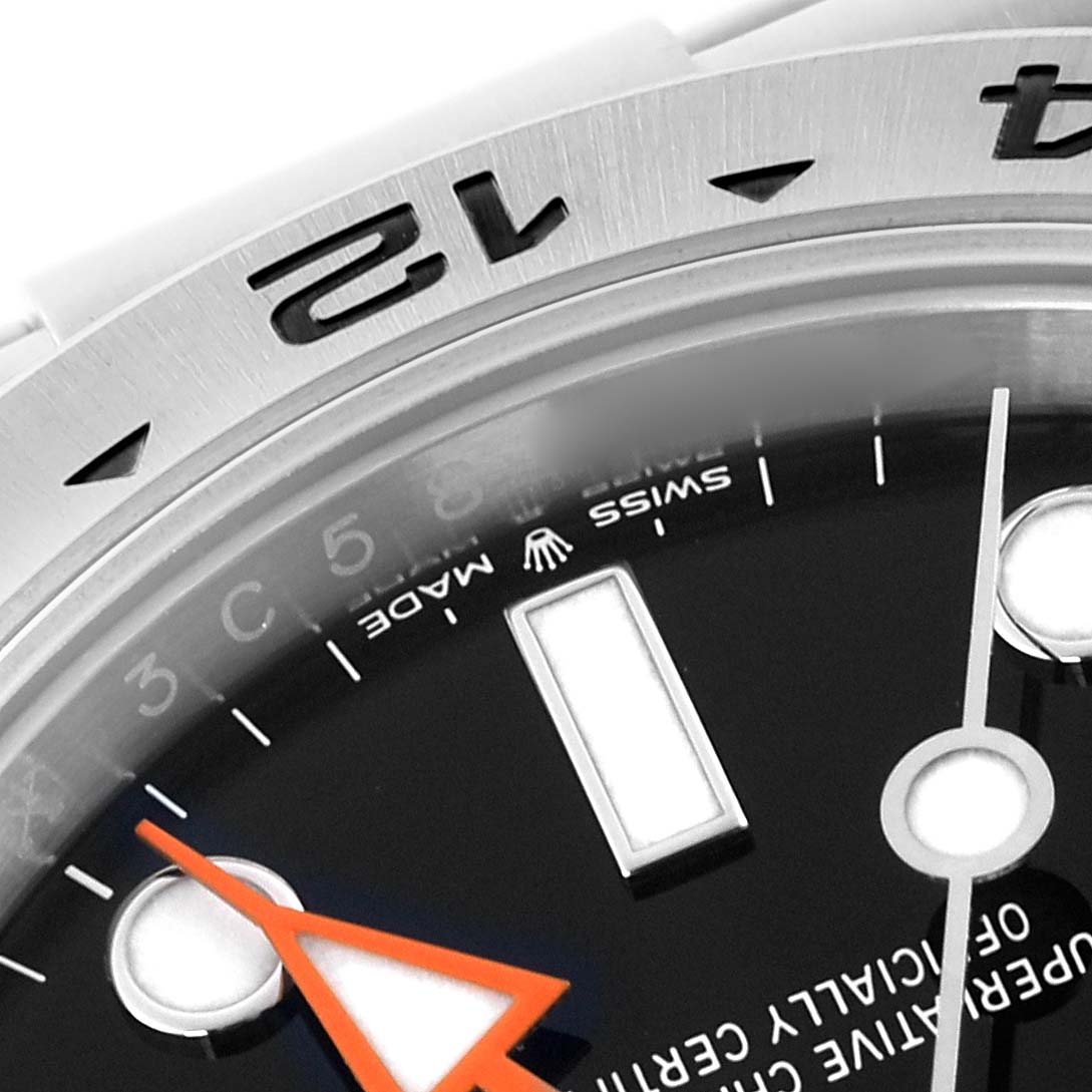 The image shows a close-up of the dial and bezel edge of a Rolex Explorer 226570-0002 Men's Stainless Steel Black Dial 226570-0002 Men's Stainless Steel Black Dial, highlighting the hour markers and part of the orange hand.