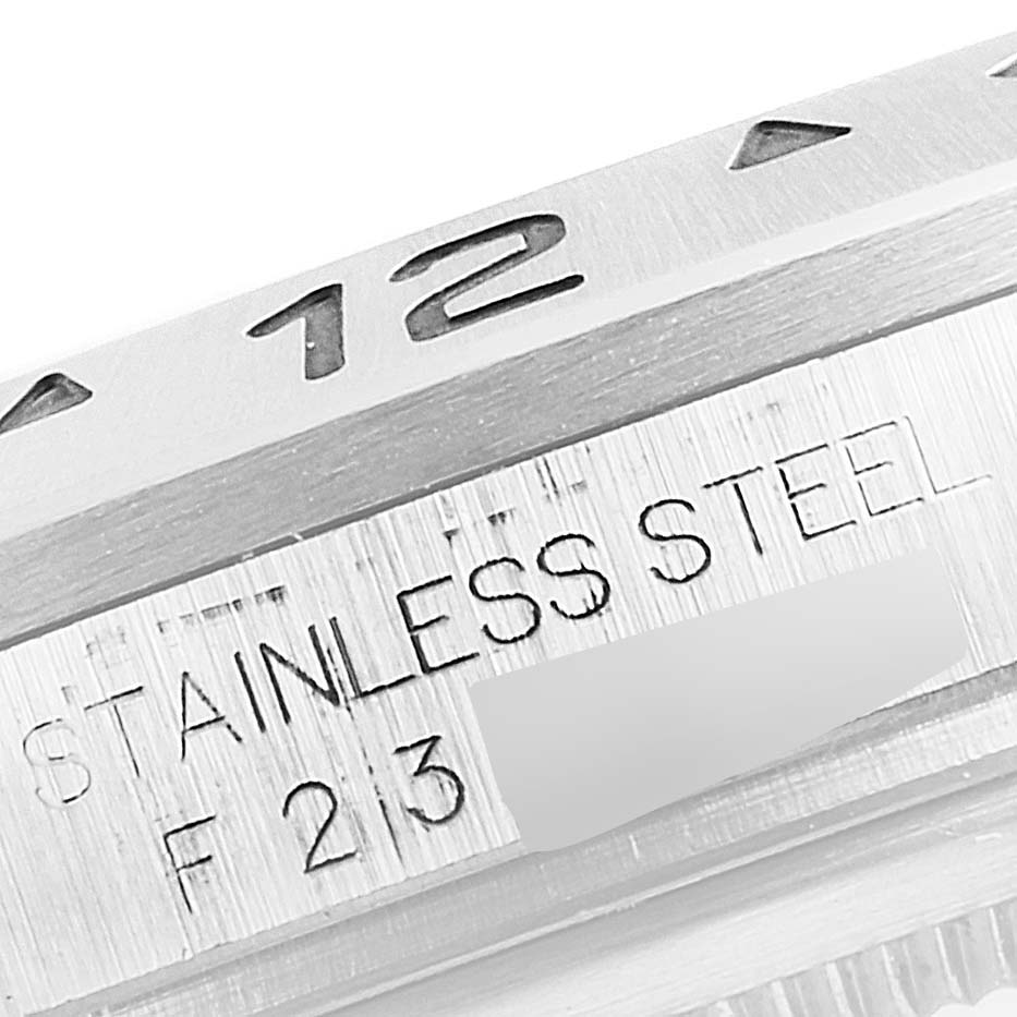 This image shows a macro view of the stainless steel engraving and part of the bezel with "12" from the Rolex Explorer 16570 Men
s Stainless Steel White Dial 16570 Men
s Stainless Steel White Dial model.