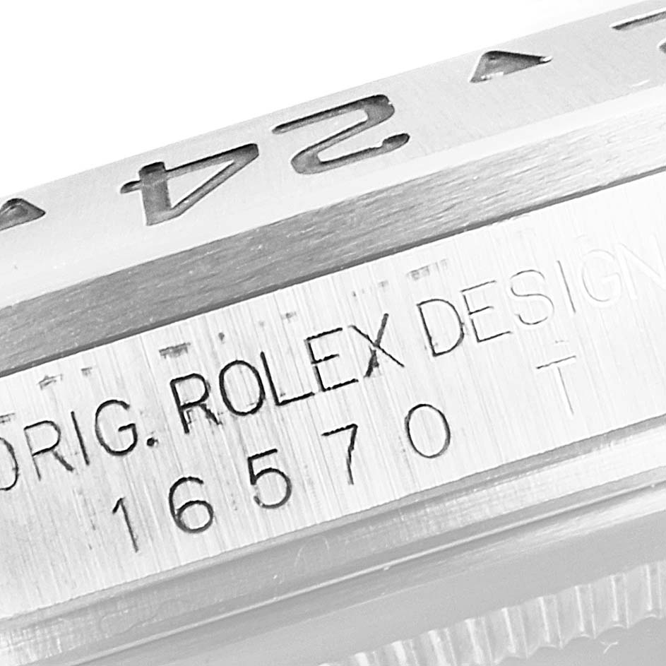 The image shows a close-up angle of the engraved serial number and part of the bezel of a Rolex Explorer 16570 Men
s Stainless Steel White Dial 16570 Men
s Stainless Steel White Dial watch.