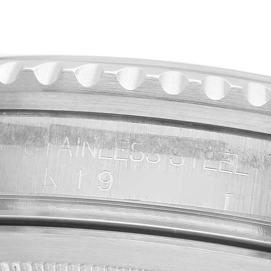 The image shows a close-up of the Rolex GMT-Master 16710 Men's Stainless Steel Black Dial's stainless steel bezel and engraved text.