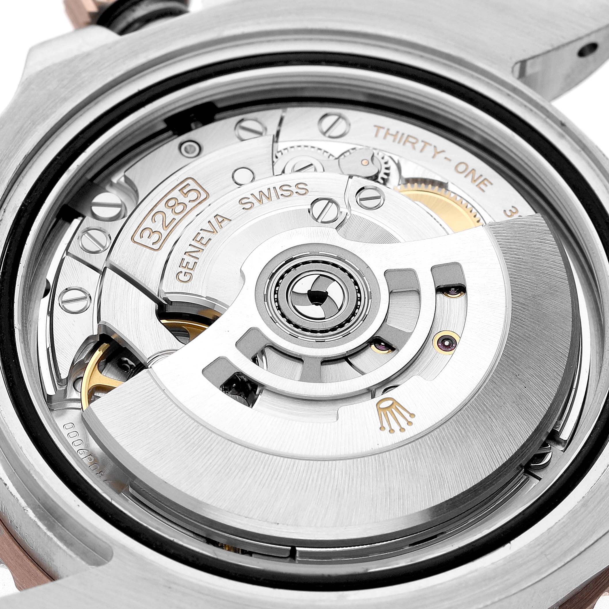 The image shows a close-up view of the Rolex GMT-Master 126711 Men's Steel and Gold (two tone) Black Dial's movement, highlighting its intricate internal mechanism.