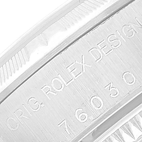 This close-up image shows the engraved text inside the bezel of the Rolex Oyster Perpetual 76030 Women's Stainless Steel Black Dial 76030 Women's Stainless Steel Black Dial model watch.