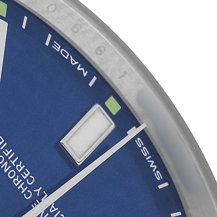 The image shows a close-up of the blue dial, markers, and part of the bezel of a Rolex Oyster Perpetual 114300 Men's Stainless Steel Blue Dial watch.