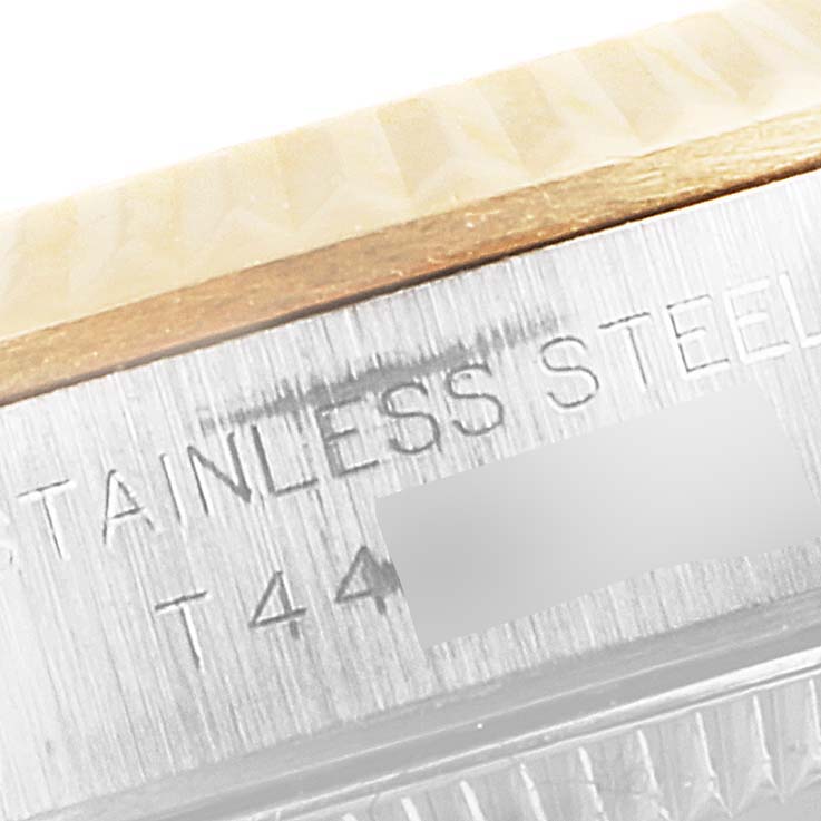 This close-up image shows the side engraving of a Rolex Oyster Perpetual 67193 Women's Steel and Gold (two tone) Champagne Dial 67193 Women's Steel and Gold (two tone) Champagne Dial watch, highlighting "STAINLESS STEEL" detailing.