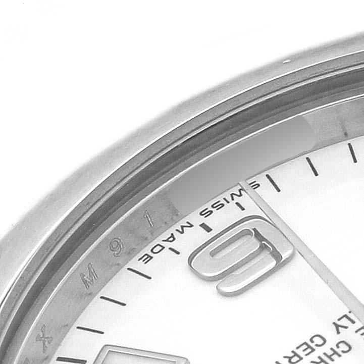 The image shows a close-up of the Rolex Oyster Perpetual 177200 Women's Stainless Steel White Dial's dial, bezel, and part of the case, focusing on the "9" marker.