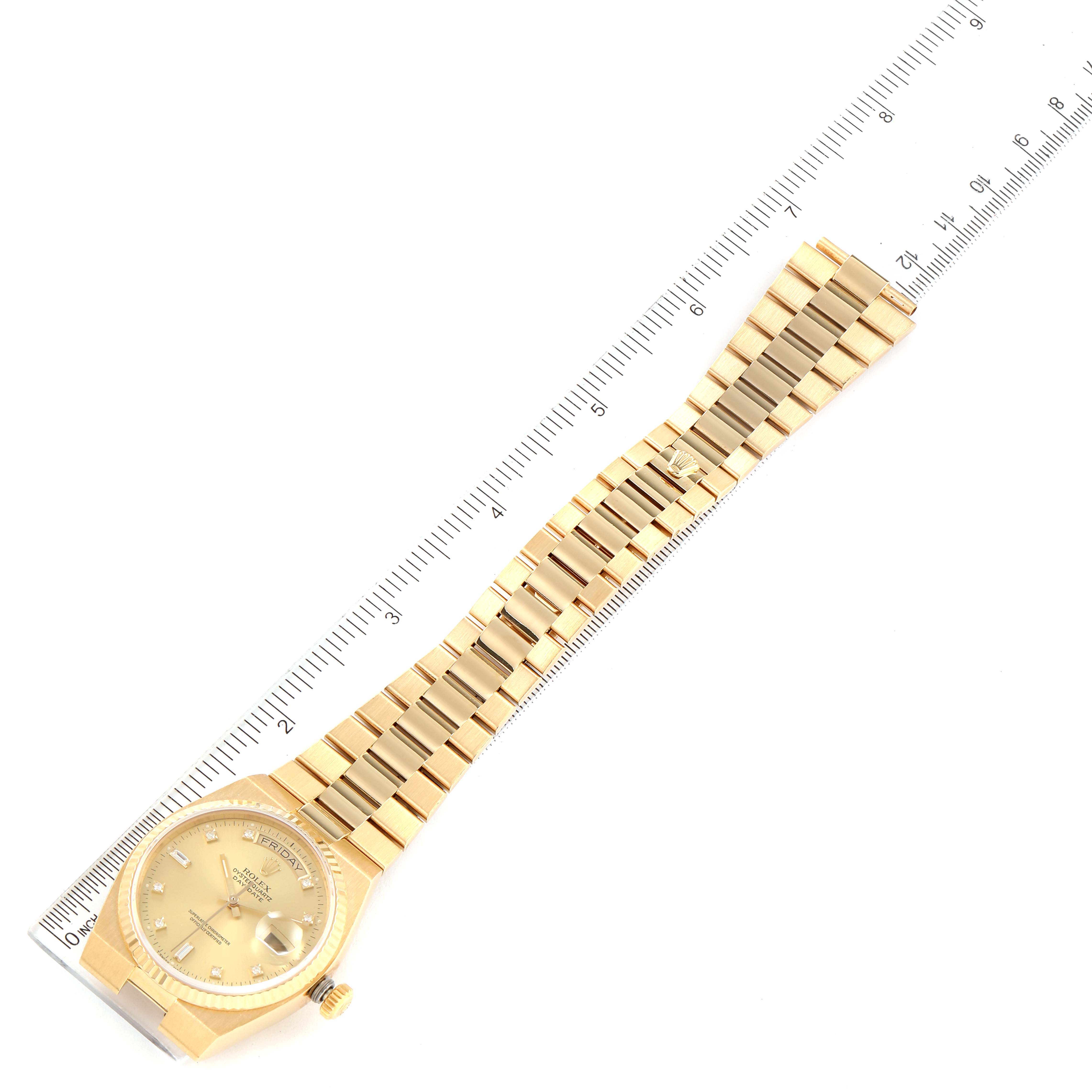 The image shows the full length of a gold Rolex President 19018 Men
s Yellow Gold Champagne Dial 19018 Men
s Yellow Gold Champagne Dial model watch, including the dial, bezel, and bracelet, alongside a ruler for scale.