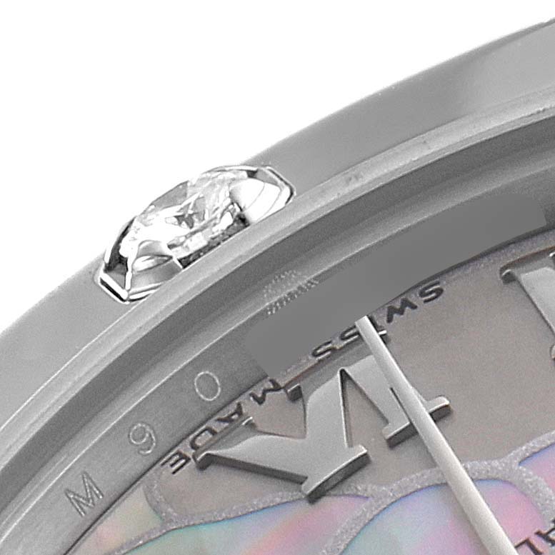 This close-up image of the Rolex Pearlmaster 81319 Women's White Gold Mother of Pearl Dial 81319 Women's White Gold Mother of Pearl Dial watch shows part of the bezel, a diamond, and a section of the dial.