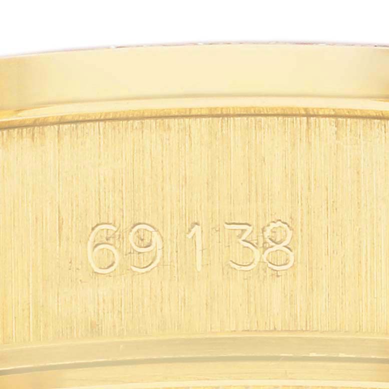 The image shows a close-up of the Rolex President 69138 Women's Yellow Gold Champagne Dial 69138 Women's Yellow Gold Champagne Dial model's gold bracelet, highlighting the reference number "69138."