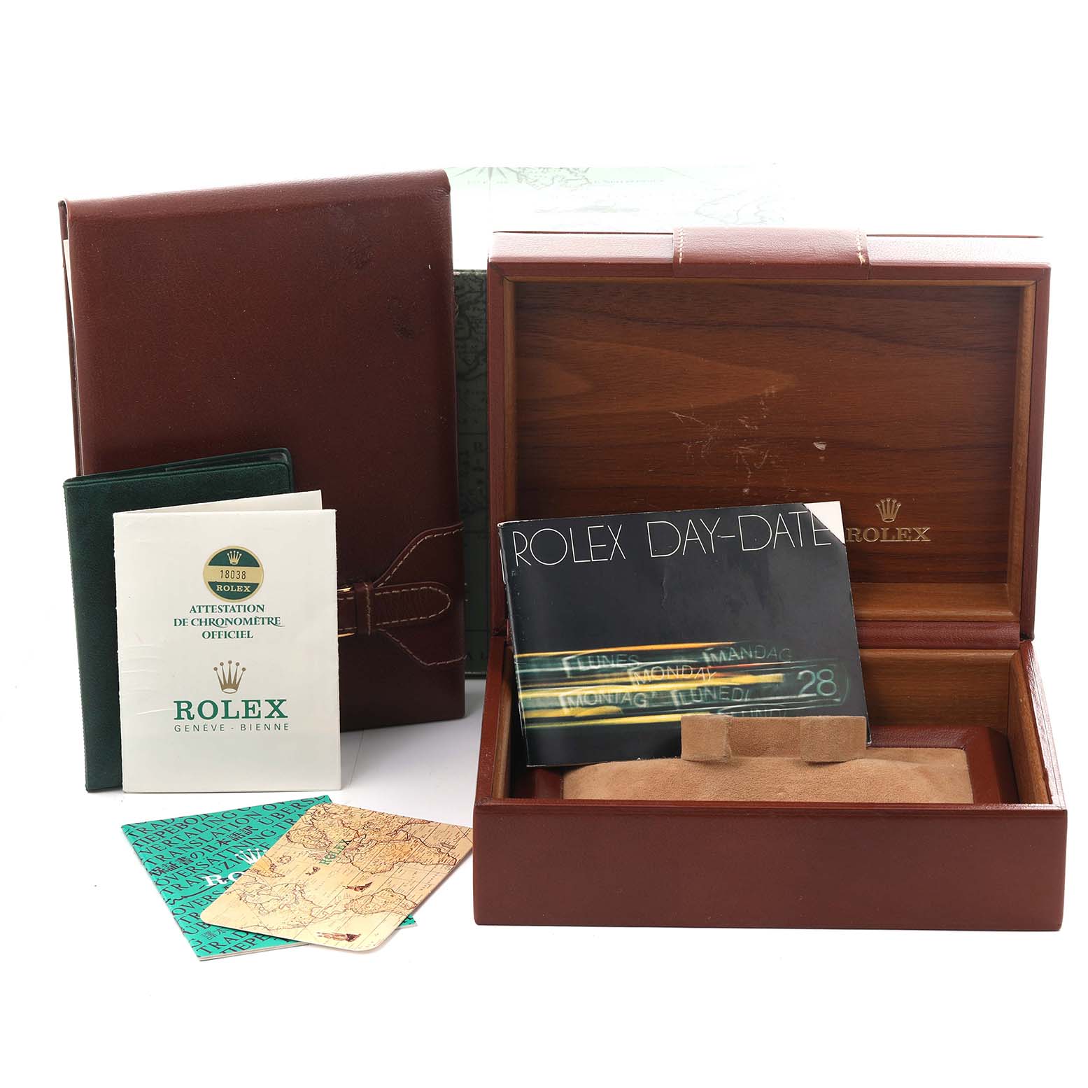 The image shows the accessories for a Rolex President 18038 Men's Yellow Gold Champagne Dial 18038 Men's Yellow Gold Champagne Dial model, including boxes, booklets, and a certificate, viewed from above.